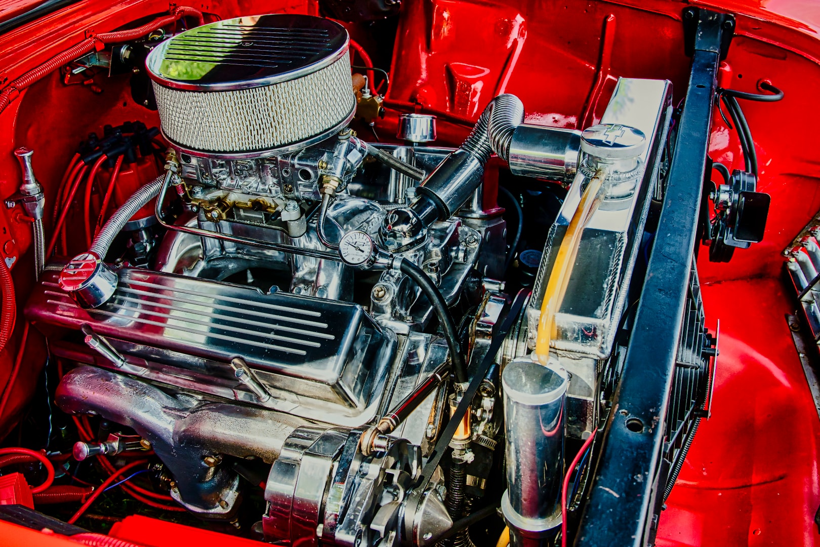 Polished chrome engine bay detail on a red classic car at the St. Clair County 4-H Fair Auto Show
