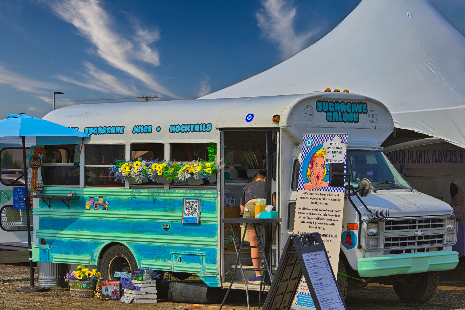 Sugarcane Galore converted school bus food truck decorated with sunflowers and colorful murals serving fresh sugarcane juice and mocktails at Blake's Lavender Festival, Armada Michigan — unique food truck and Michigan festival event photography by Atelier Lens LLC