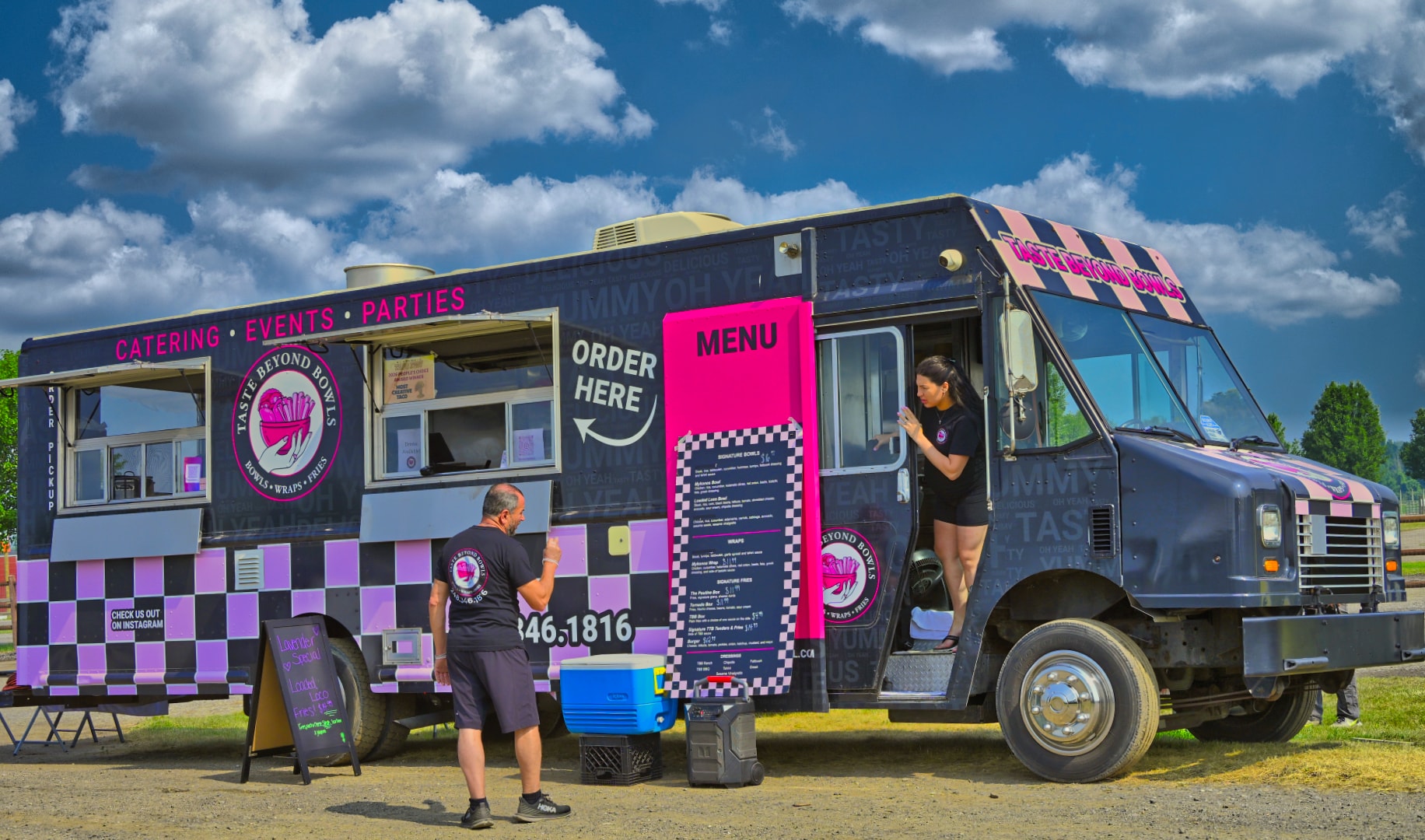 Taste Beyond Bowls food truck with bold pink and black checkered wrap serving bowls, wraps, and fries at Blake's Lavender Festival, Blake's Apple Orchard, Armada Michigan — food truck and festival event photography by Atelier Lens LLC