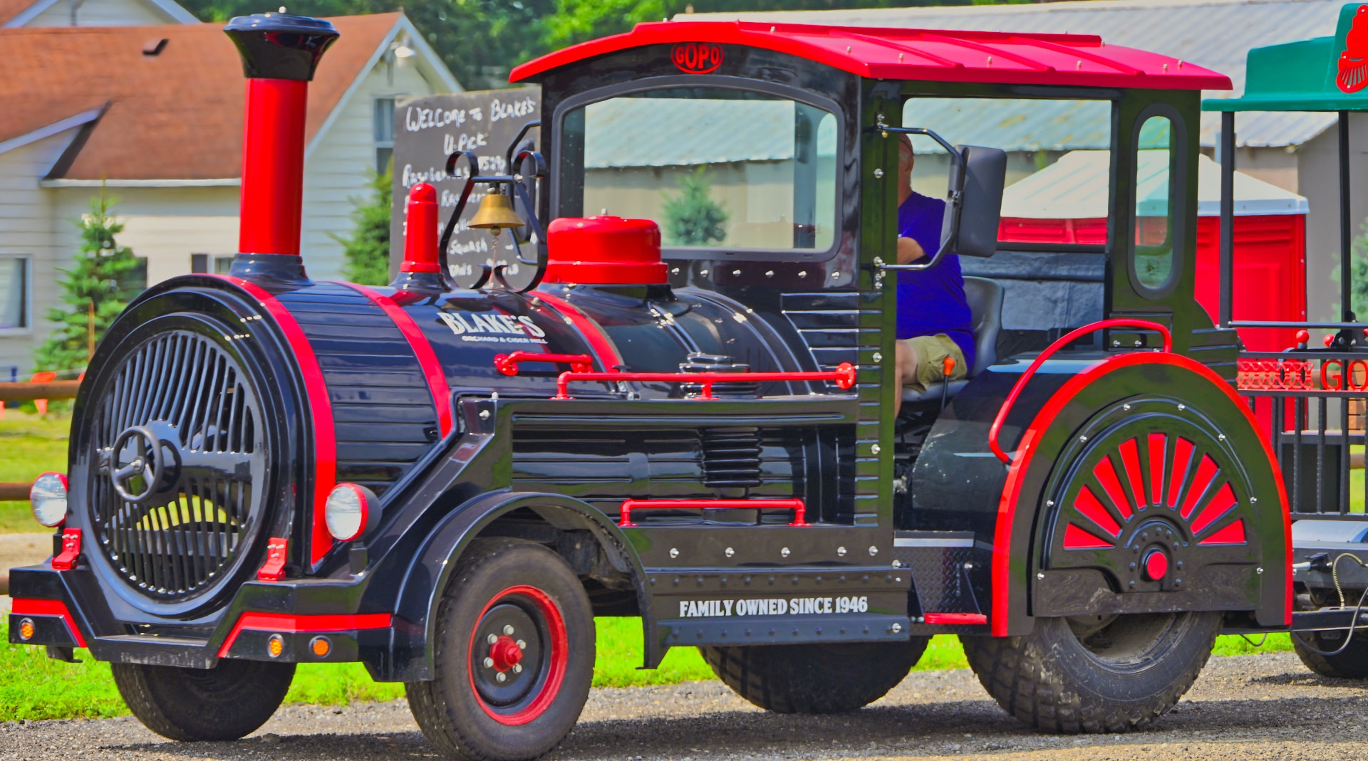 Blake's Orchard & Cider Mill branded passenger train engine — black and red with Family Owned Since 1946 lettering and Welcome to Blake's U-Pick chalkboard sign — commercial property photography, Armada, Michigan by Atelier Lens LLC