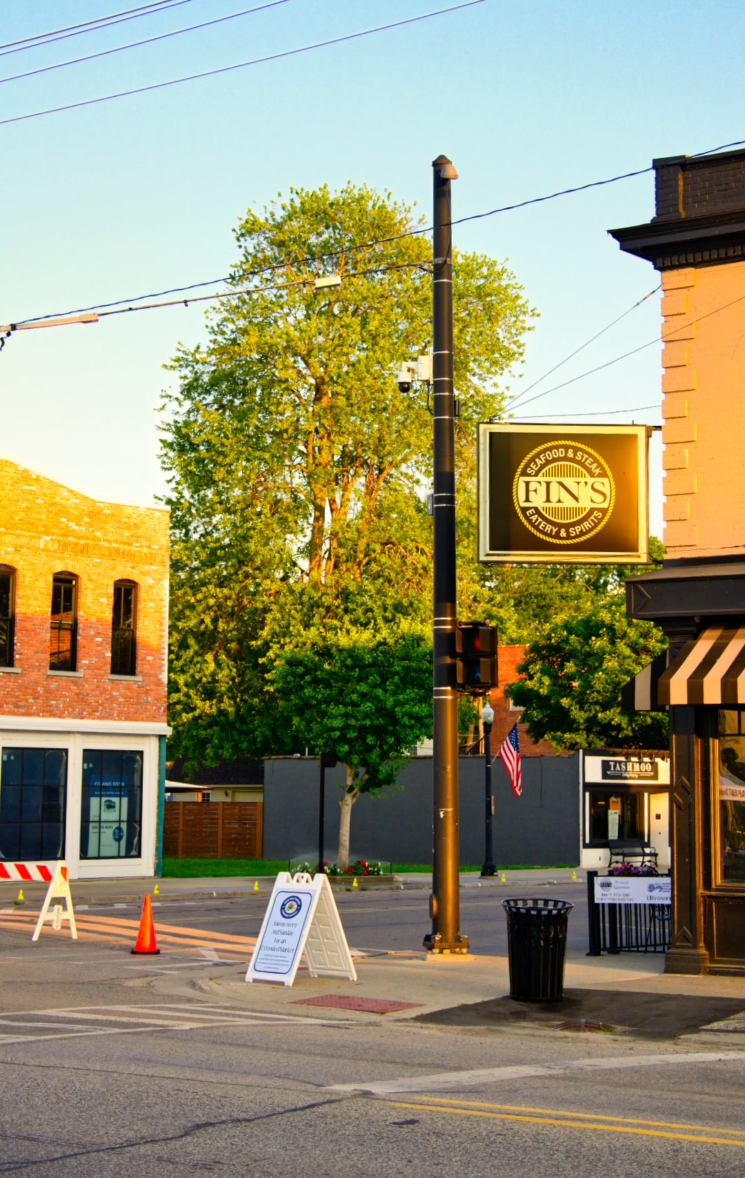Fin's Eatery & Spirits sign at sunrise on Main Street New Baltimore Michigan — location photography by Atelier Lens LLC