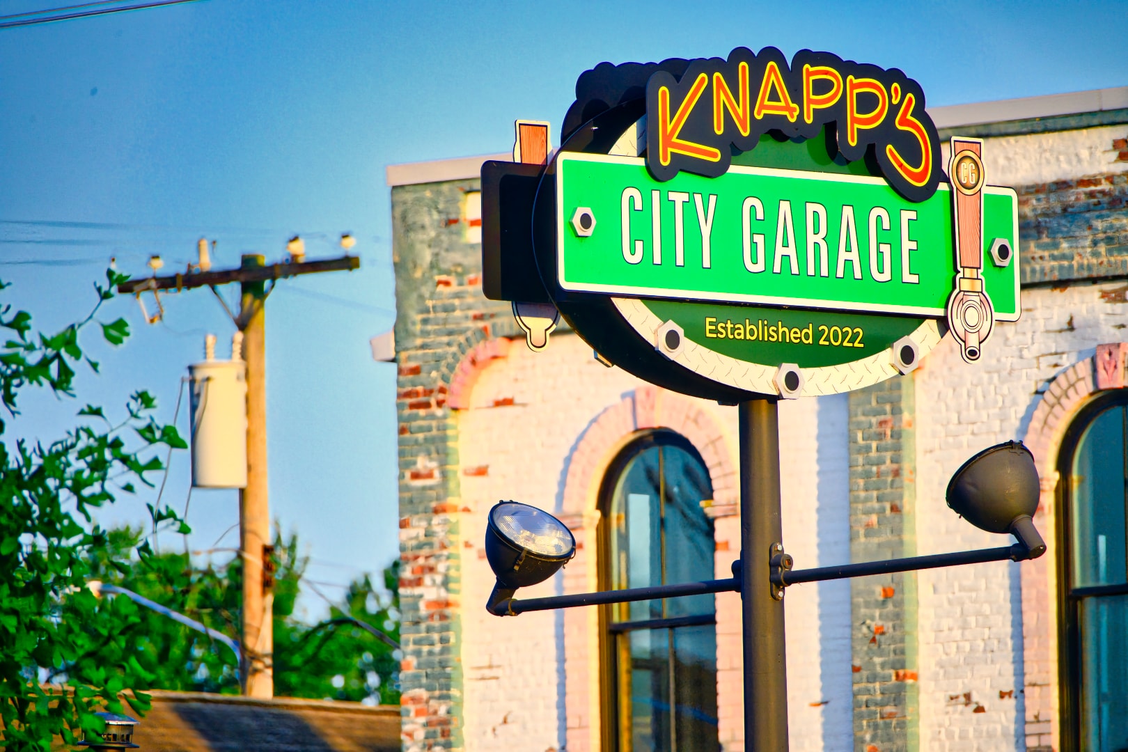 Knapp's City Garage neon sign on historic brick building in New Baltimore Michigan — commercial signage photography by Atelier Lens LLC