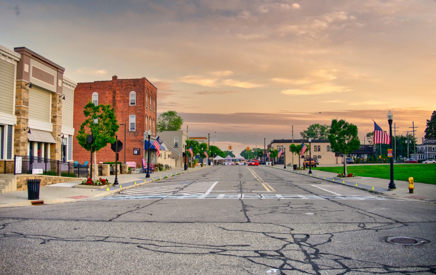 Main Street New Baltimore Michigan at sunrise with American flags and historic storefronts — Macomb County location photography by Atelier Lens LLC