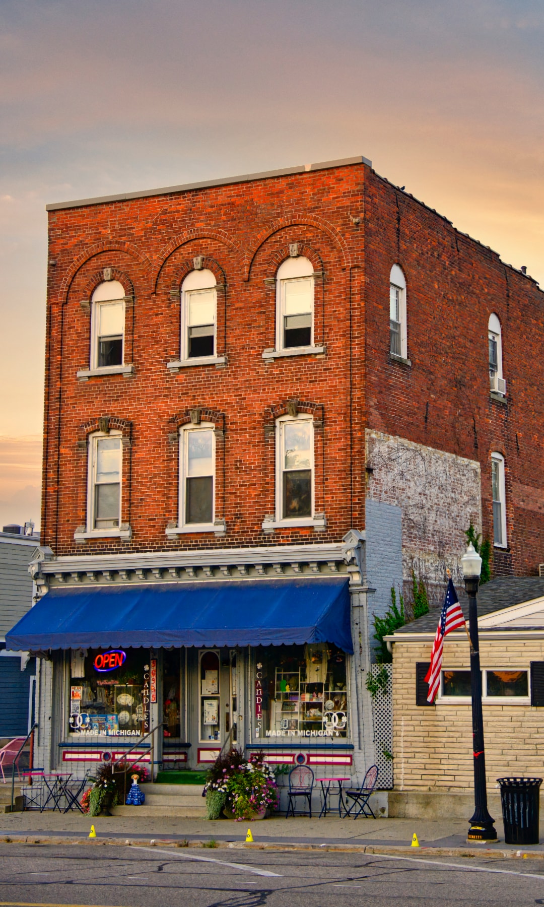 Historic brick storefront on Main Street New Baltimore Michigan at golden hour — architectural photography by Atelier Lens LLC